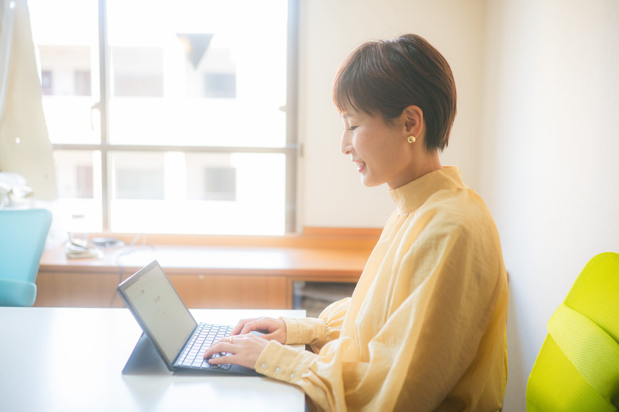 ノートPCで作業するシングルマザーの女性経営者・坂田早希さん